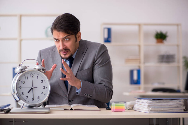 Young male employee in time management concept - Photo, Image
