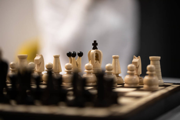 Chess pieces on board in initial position on blurred background - Photo, Image