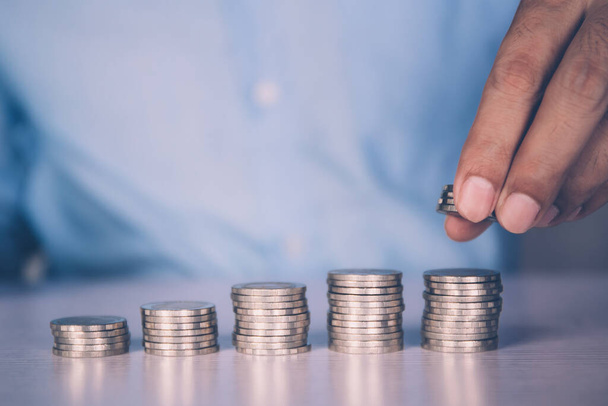 Hands of businessman put coin stack with increase growth, finance and saving, investment for profit and success, planning with financial, growing economy and fund, stock and income, business concept. - Photo, Image