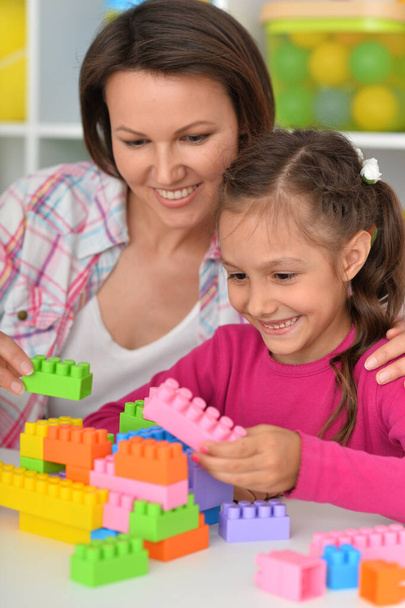 cute little girl playing with colorful clay blocks at home - Foto, Imagem