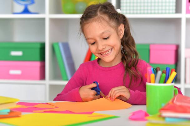 cute little girl is cutting paper - Photo, Image