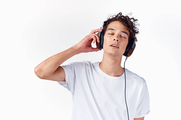 Cheerful guy with curly hair in headphones music lifestyle - Fotoğraf, Görsel