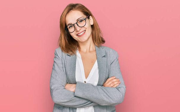 Young caucasian woman wearing business style and glasses happy face smiling with crossed arms looking at the camera. positive person.  - Photo, Image