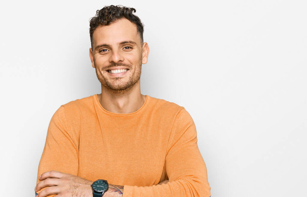Young hispanic man wearing casual clothes happy face smiling with crossed arms looking at the camera. positive person.  - Photo, Image