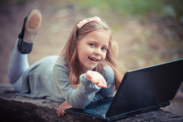Child in  park with laptop - Фото, изображение