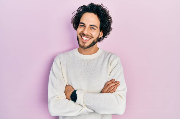Handsome hispanic man wearing casual white sweater happy face smiling with crossed arms looking at the camera. positive person.  - Photo, Image