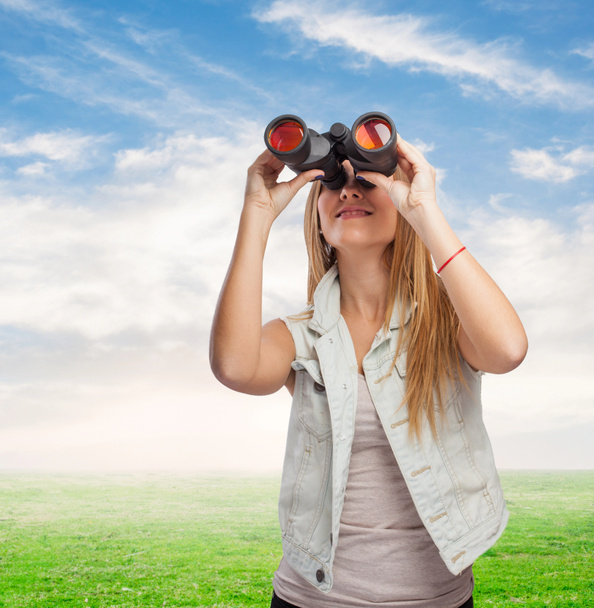 Woman looking through binoculars - Photo, Image