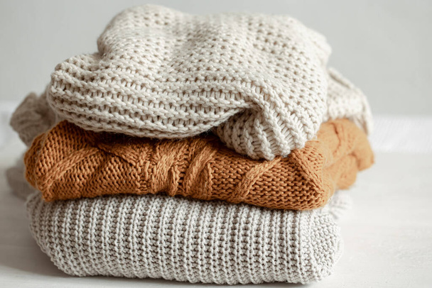 A stack of neatly folded warm knitwear, wool close up. - Photo, Image