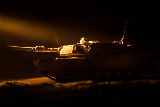 War Concept. Armored vehicle silhouette fighting scene on war foggy sky background at night. American tank ready to fight. Creative decoration - Photo, Image