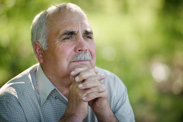 Elderly man sitting thinking - Φωτογραφία, εικόνα