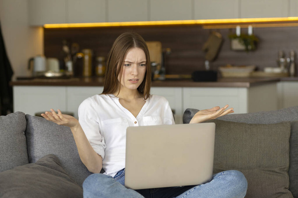 Millennial girl sit at desk at home or office working or studying on laptop in living room - Foto, immagini