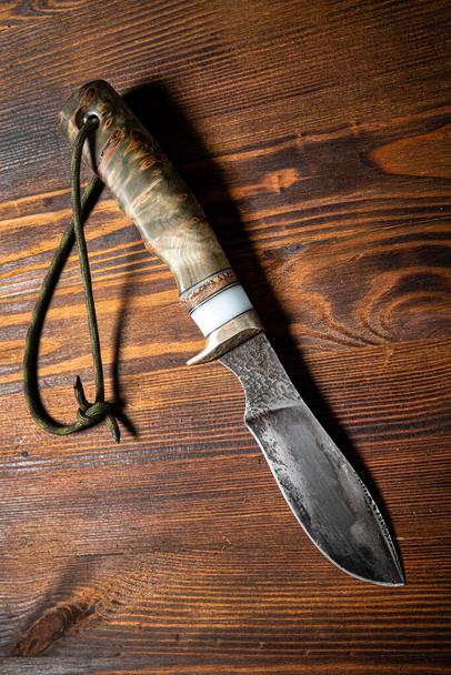 Hunting knife handmade on a wooden background - Φωτογραφία, εικόνα