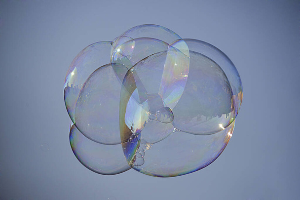 The soap bubbles floating in a blue sky - Foto, Imagen