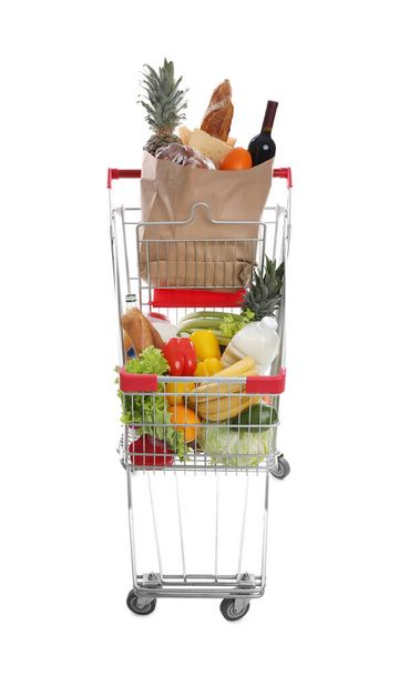 Shopping cart with groceries on white background - Foto, imagen