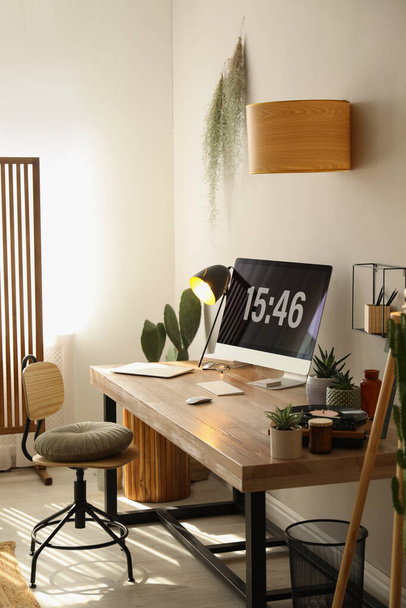 Room interior with comfortable workplace. Modern computer on wooden desk - Valokuva, kuva