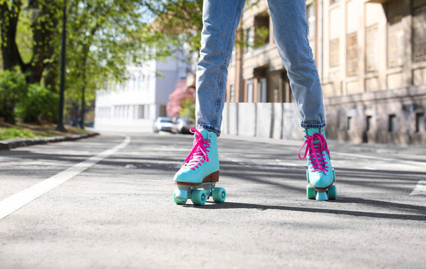 Woman roller skating outdoors on sunny day, closeup - Фото, изображение