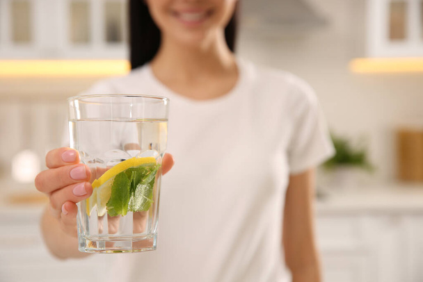 Young woman with glass of fresh lemonade at home, closeup - Foto, immagini