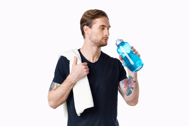 sporty man in black t-shirt workout water bottle - Photo, image
