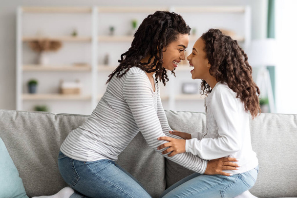 Cheerful black mother and daughter having fun together at home - Foto, Imagen