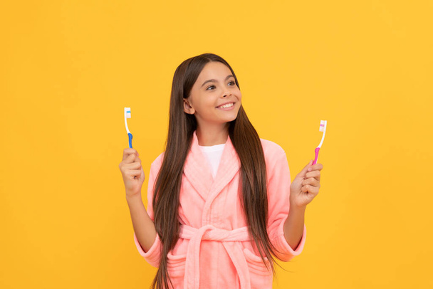 dreamy happy teen girl in home terry bathrobe hold toothbrush, health. - Photo, Image