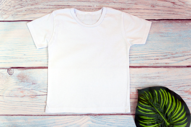White t-shirt mockup on wooden background, top view, stock photo, - Photo, Image