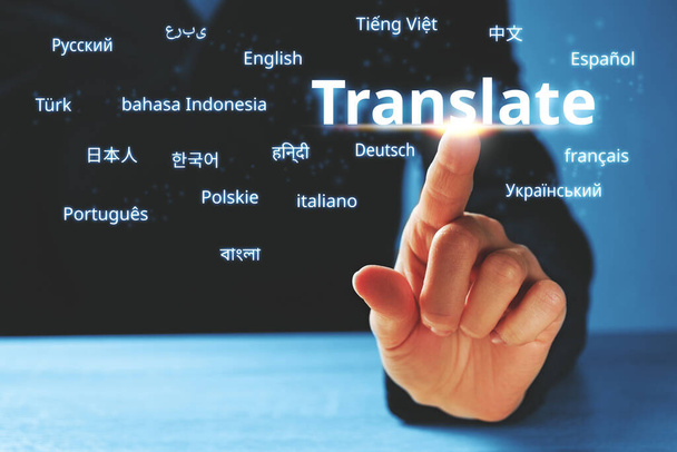 Person abstractly presses on the display with the word translate and foreign languages. - Fotoğraf, Görsel