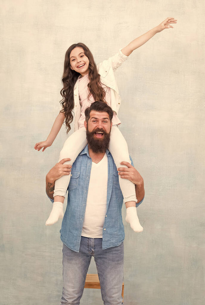 Happy family of bearded man ride little daughter child on shoulders, happiness - Foto, imagen