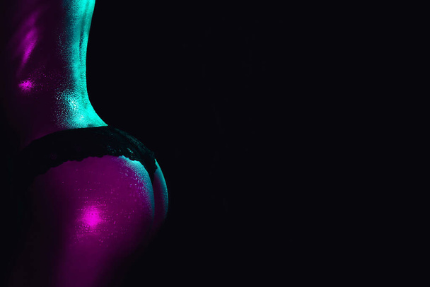 sexy female ass in panties on a dark background. Silhouette of a beautiful slender female body - Fotografie, Obrázek