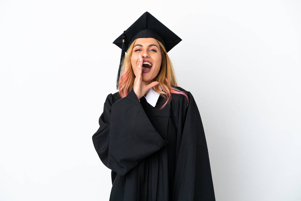 Young university graduate over isolated white background shouting with mouth wide open - Fotografie, Obrázek