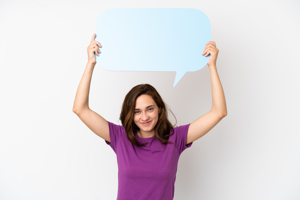 Young caucasian woman isolated on white background holding an empty speech bubble - Photo, Image
