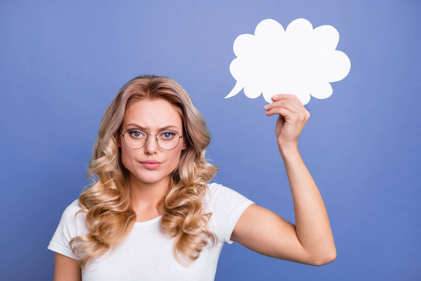 Photo of young attractive woman serious hold paper cloud think idea plan isolated over blue color background - Photo, image