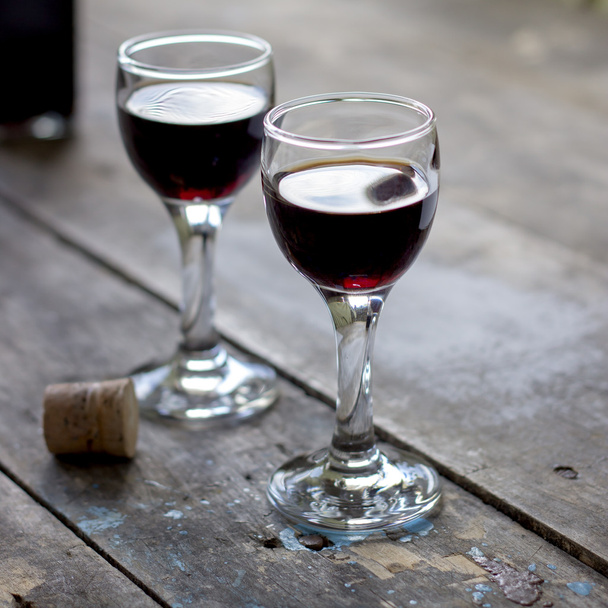 glass of cherry liqueur on wooden table - Fotó, kép