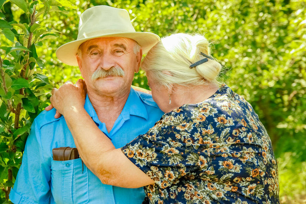 happy portrait of an elderly couple on the nature background - Fotó, kép