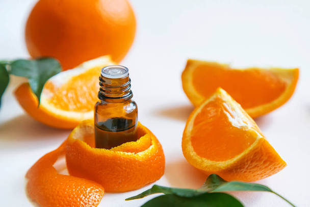 Orange essential oil in a small bottle. Selective focus. Food. - Foto, afbeelding