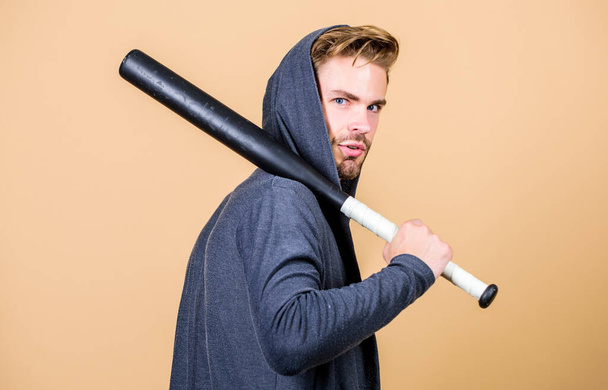 Man bully guy with baseball bat. Strong and confident. Self defence. Sport equipment. Sportsman strong looks threatening with bat. Aggression masculinity strong temper. Bully mood. Bad boy concept - 写真・画像