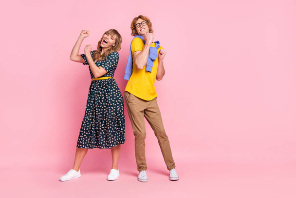 Full size photo of optimistic nice couple dance wear colorful clothes isolated on pastel pink background - Foto, afbeelding