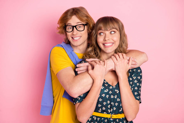 Photo of optimistic nice couple hug wear colorful clothes isolated on pastel pink background - Foto, afbeelding