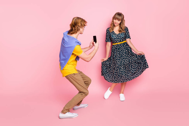 Full size photo of optimistic nice couple make photo wear colorful clothes isolated on pastel pink background - Photo, Image