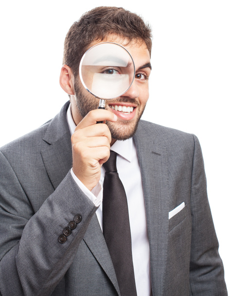 Businessman looking through magnifying glass - Foto, Imagem