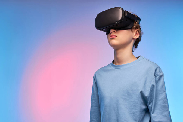 Confident Teenage Boy In VR Glasses Looking Away Seriously, Imagine Something Fantastic - Foto, afbeelding