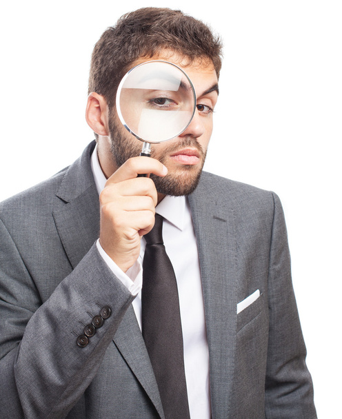 Business man looking through magnifying glass - Photo, Image