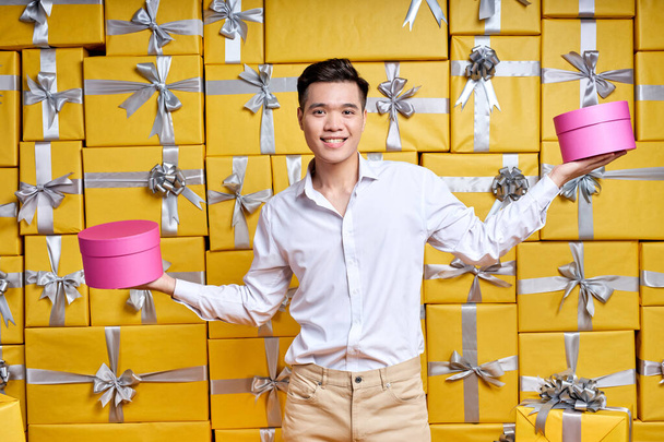 Time For Celebration. Portrait of emotional asian guy holding present box in hands, going to congratulate - Foto, immagini