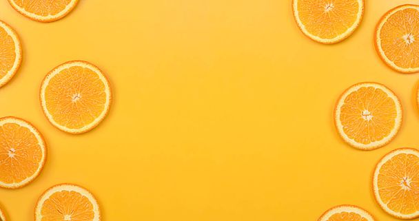 orange fruit on an orange background. summer background - Фото, изображение