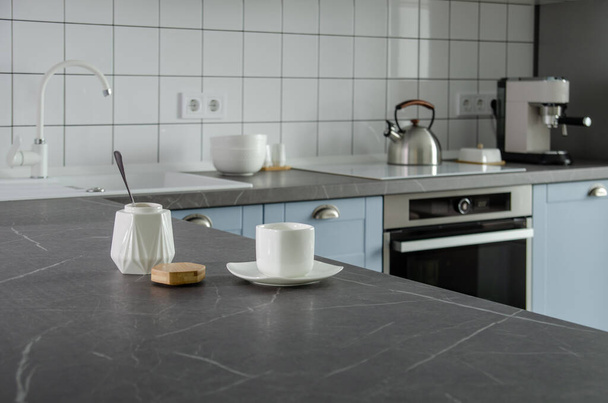 Modern stylish blue and gray kitchen with tea and coffee making facilities - Φωτογραφία, εικόνα