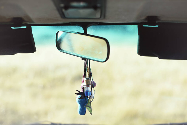 Detail of rear-view mirror in the interior of a rural van - Photo, Image