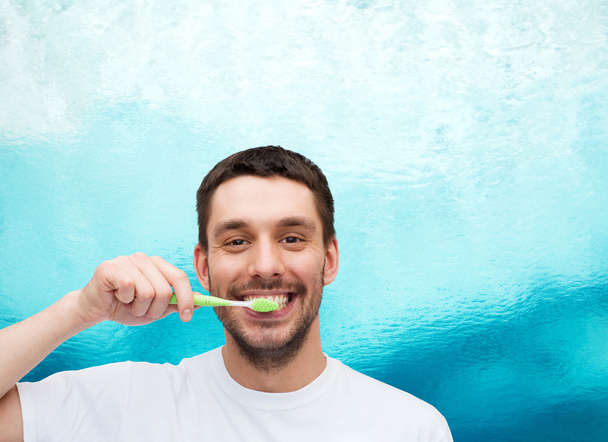 smiling young man with toothbrush - Foto, Imagem