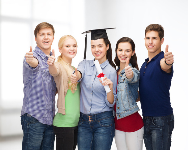 group of students with diploma showing thumbs up - Fotografie, Obrázek