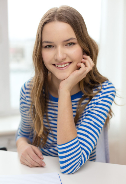smiling teenage girl with notebook at home - Valokuva, kuva