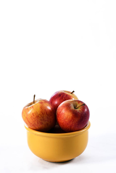 натуральные и здоровые тропические фрукты яблоко в миске на столе на размытом фоне текстуры - Фото, изображение