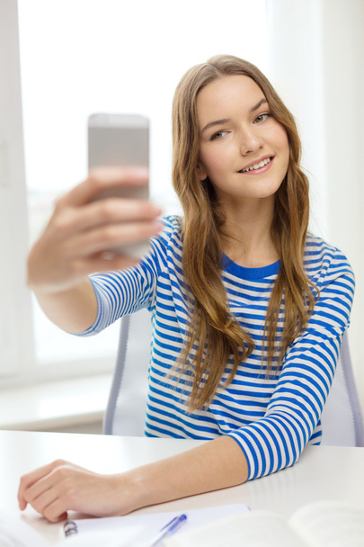 smiling student girl with smartphone and books - Fotoğraf, Görsel